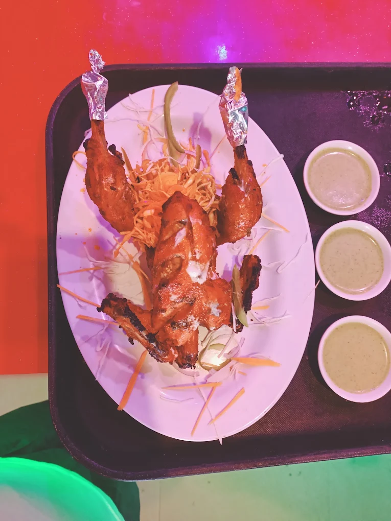 Whole tandoori chicken served with salad and house sauces
