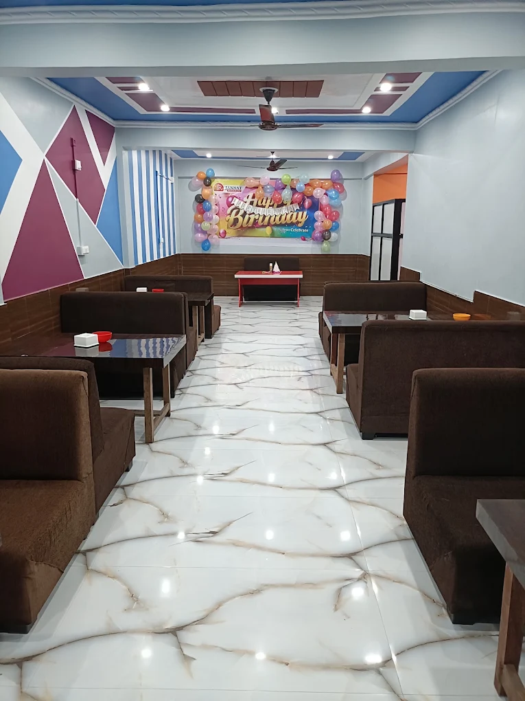Spacious dining hall with booth seating and party setup